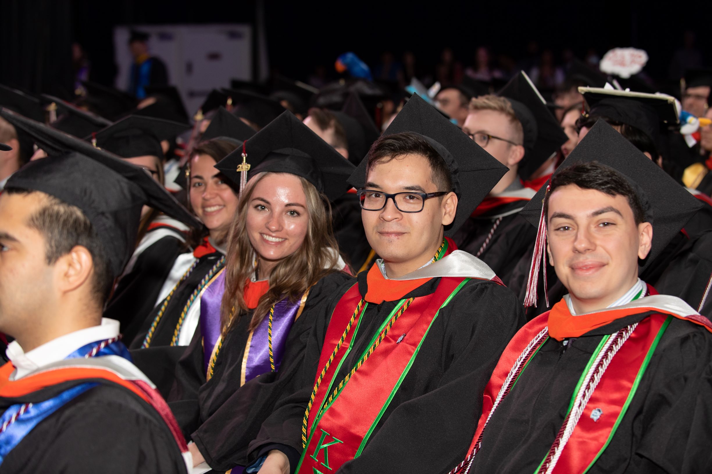 Undergraduate students smile on graduation day